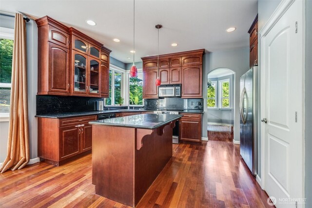 36984 Aspen Way NE, Hansville, WA 98340 - kitchen with appliances with stainless steel finishes, dark countertops, baseboards, arched walkways, and recessed lighting
