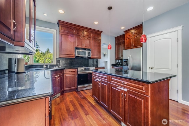 36984 Aspen Way NE, Hansville, WA 98340 - kitchen with stainless steel appliances, a sink, dark wood-type flooring, backsplash, and decorative light fixtures