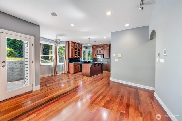 36984 Aspen Way NE, Hansville, WA 98340 - kitchen with a center island, baseboards, a breakfast bar, wood finished floors, and recessed lighting