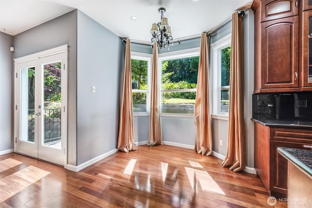 36984 Aspen Way NE, Hansville, WA 98340 - unfurnished dining area with a chandelier, plenty of natural light, wood finished floors, and baseboards