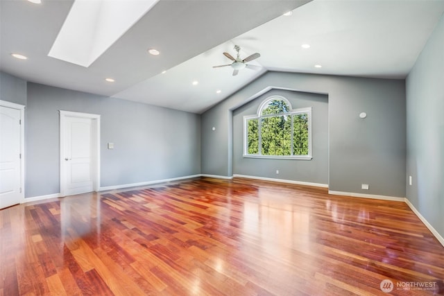 36984 Aspen Way NE, Hansville, WA 98340 - empty room featuring wood finished floors, lofted ceiling, a ceiling fan, baseboards, and a skylight