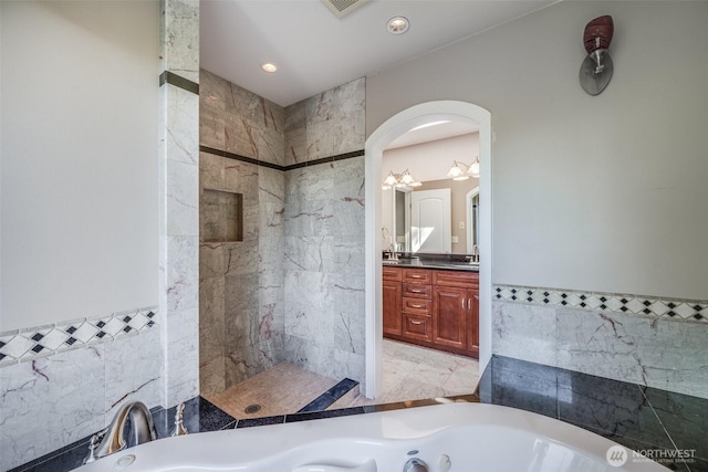 36984 Aspen Way NE, Hansville, WA 98340 - full bathroom with tile walls, a tub with jets, vanity, tiled shower, and wainscoting