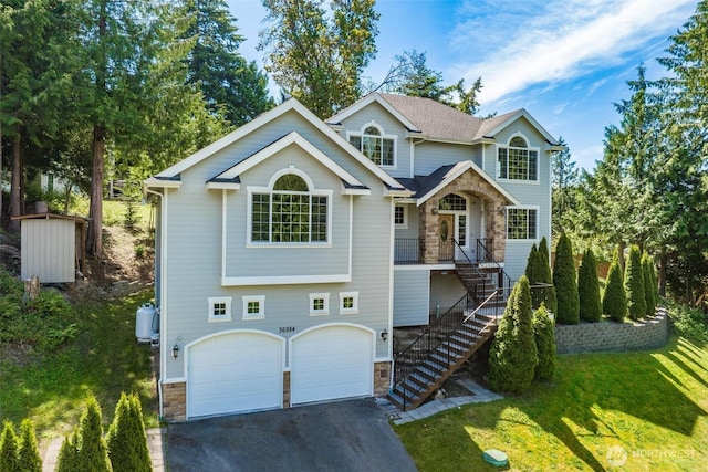36984 Aspen Way NE, Hansville, WA 98340 - view of front facade featuring stone siding, stairway, an attached garage, and driveway