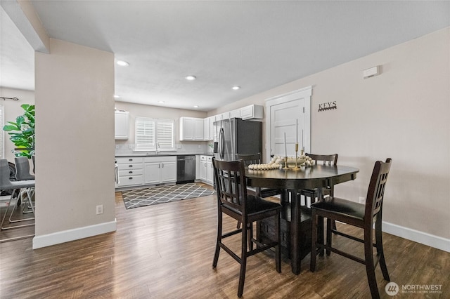 dining space featuring recessed lighting, baseboards, and dark wood finished floors