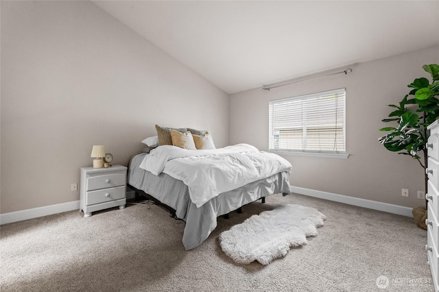 carpeted bedroom with baseboards and lofted ceiling