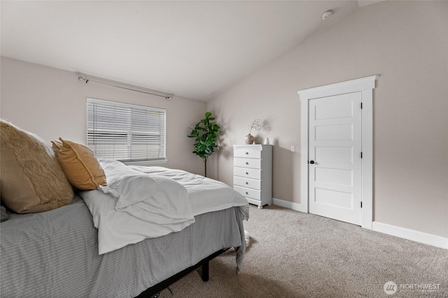 bedroom featuring light carpet, baseboards, and lofted ceiling