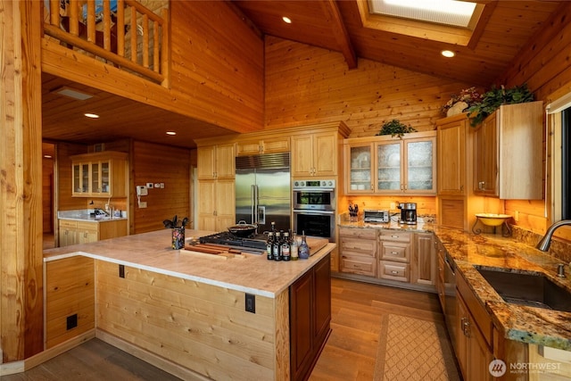 121 Marine Dr, Blakely Island, WA 98222 - kitchen featuring wood finished floors, a sink, light stone counters, and appliances with stainless steel finishes