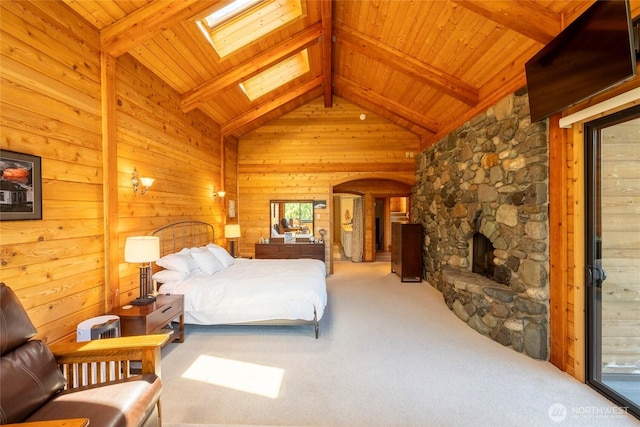 121 Marine Dr, Blakely Island, WA 98222 - carpeted bedroom featuring a fireplace, wooden walls, lofted ceiling with skylight, arched walkways, and wood ceiling