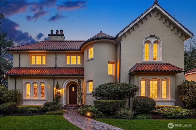 180 Lake Washington Blvd E, Seattle, WA 98112 - mediterranean / spanish house with stucco siding, a chimney, a front lawn, and a tile roof