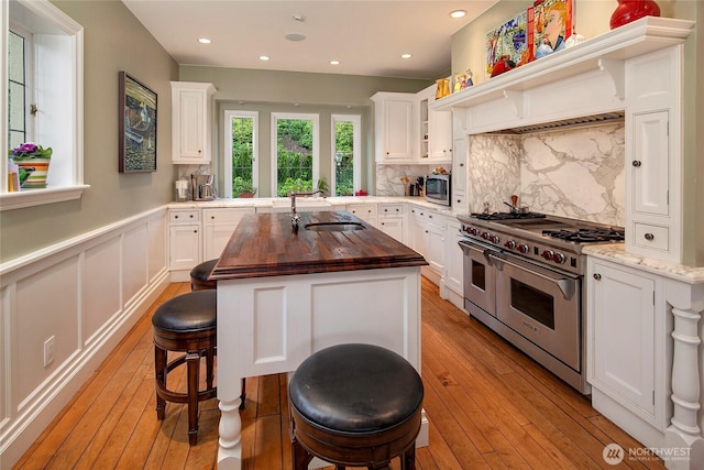 180 Lake Washington Blvd E, Seattle, WA 98112 - kitchen featuring butcher block countertops, light wood-type flooring, a sink, and appliances with stainless steel finishes