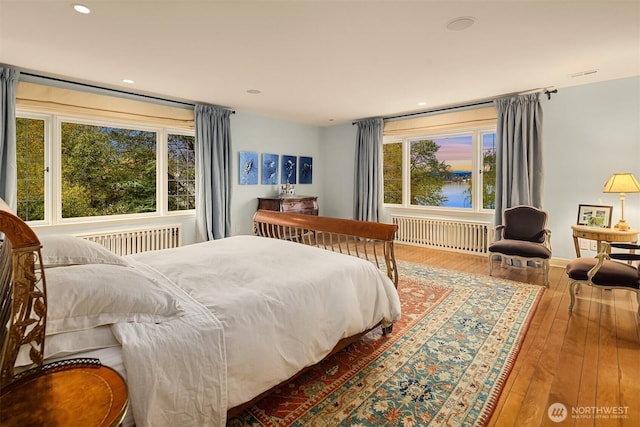 180 Lake Washington Blvd E, Seattle, WA 98112 - bedroom featuring radiator heating unit, wood-type flooring, and multiple windows