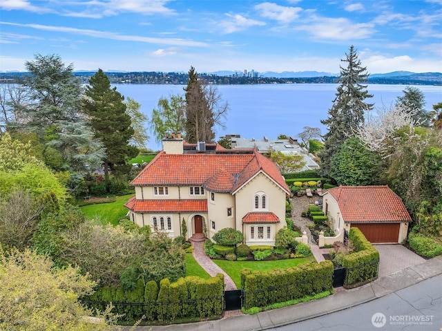 180 Lake Washington Blvd E, Seattle, WA 98112 - exterior space with stucco siding, an outdoor structure, a water and mountain view, a tile roof, and a chimney