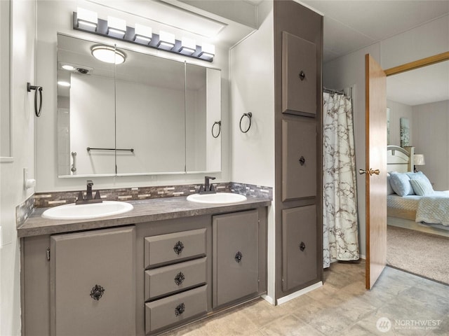 ensuite bathroom with a sink, double vanity, and ensuite bath