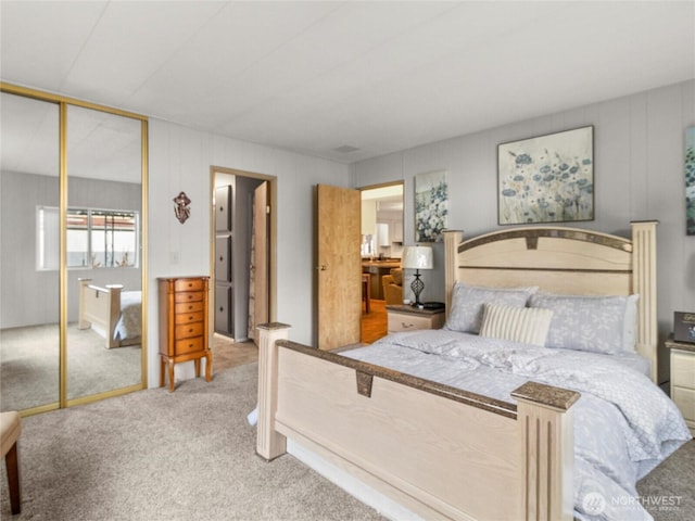bedroom featuring a closet and light colored carpet