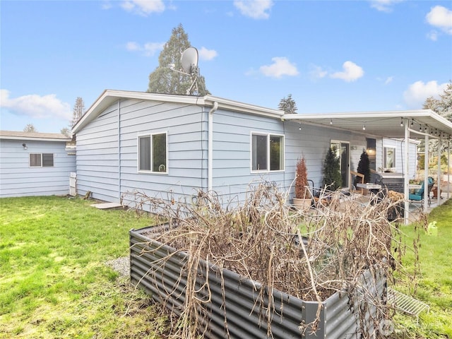 back of property featuring a lawn
