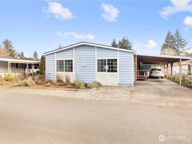 view of front of house featuring a carport and driveway