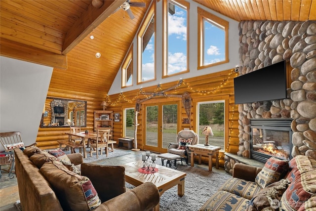 living area featuring high vaulted ceiling, a ceiling fan, a stone fireplace, wooden ceiling, and log walls
