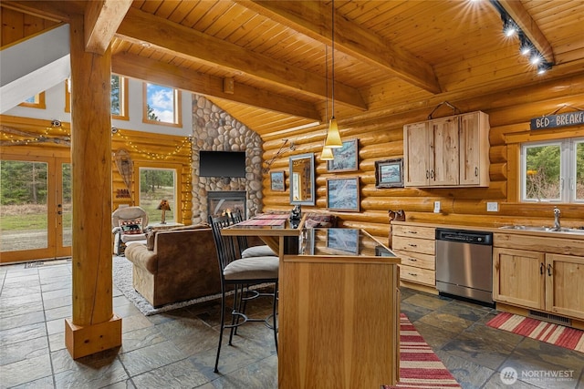 kitchen with a sink, a fireplace, stone tile flooring, stainless steel dishwasher, and wooden ceiling