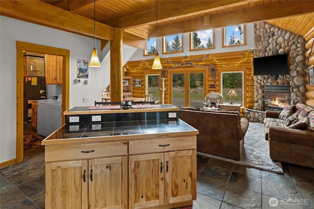 kitchen featuring tile counters, open floor plan, stone tile floors, and wood ceiling