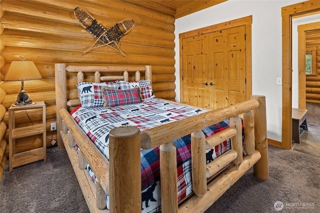 bedroom with carpet and rustic walls