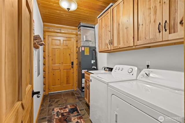 laundry area with washer and dryer, wood ceiling, stone finish flooring, and cabinet space