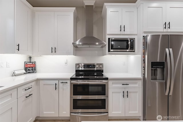 6321 Pony Pl, Maple Falls, WA 98266 - kitchen featuring wall chimney range hood, white cabinets, light countertops, and appliances with stainless steel finishes