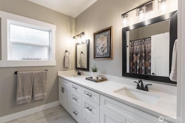 6321 Pony Pl, Maple Falls, WA 98266 - bathroom with baseboards, double vanity, marble finish floor, and a sink