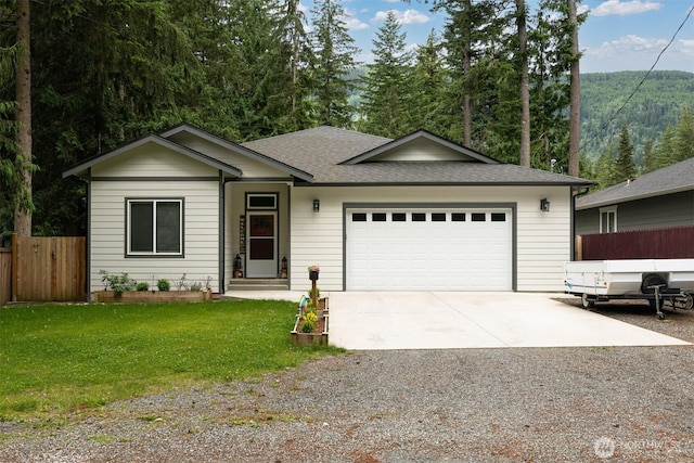 6321 Pony Pl, Maple Falls, WA 98266 - ranch-style home featuring a garage, roof with shingles, a front yard, fence, and concrete driveway