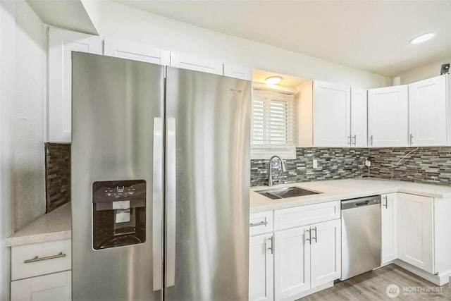 1016 Dearborn Ave, Shelton, WA 98584 - kitchen with light countertops, appliances with stainless steel finishes, decorative backsplash, and a sink