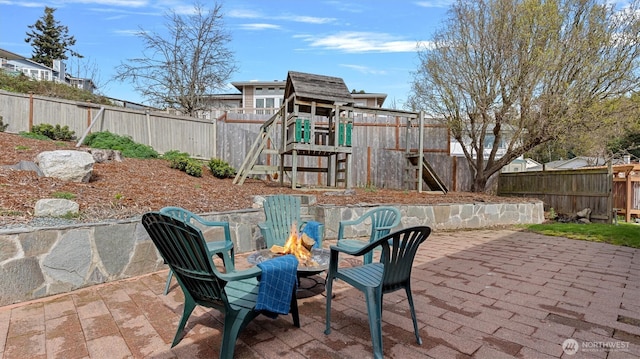 4504 Queen Ann Way, Anacortes, WA 98221 - fenced backyard with a playground, a fire pit, and a patio