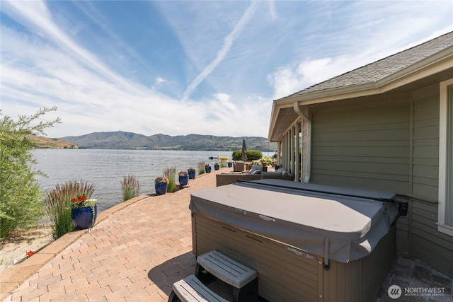 215 Wall St, Manson, WA 98831 - view of patio featuring a hot tub and a water and mountain view