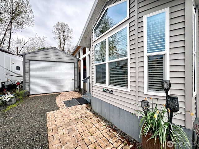 view of home's exterior with a patio and an outbuilding