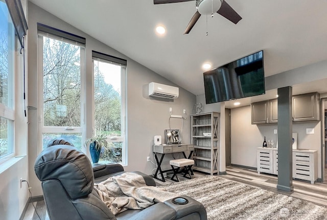 living area featuring a wall unit AC, a ceiling fan, recessed lighting, lofted ceiling, and light wood finished floors