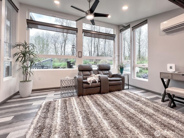 sunroom featuring wood finished floors, baseboards, an AC wall unit, and recessed lighting