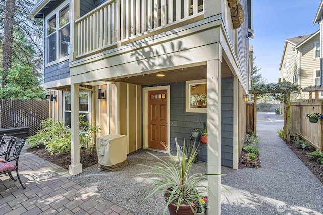 property entrance with a patio area and fence