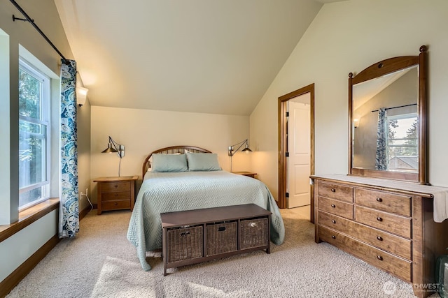 carpeted bedroom with baseboards and vaulted ceiling