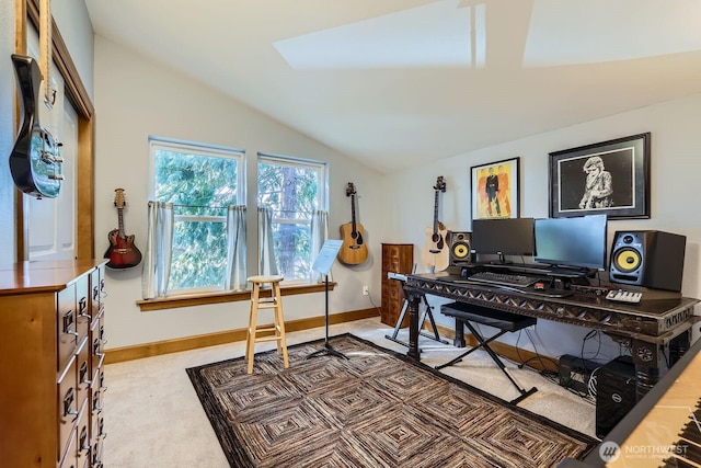office area with baseboards and lofted ceiling with skylight