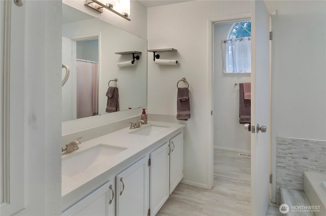 9410 175th Street Ct E, Puyallup, WA 98375 - bathroom with a bath, double vanity, a sink, and visible vents