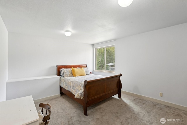 bedroom with baseboards and carpet flooring