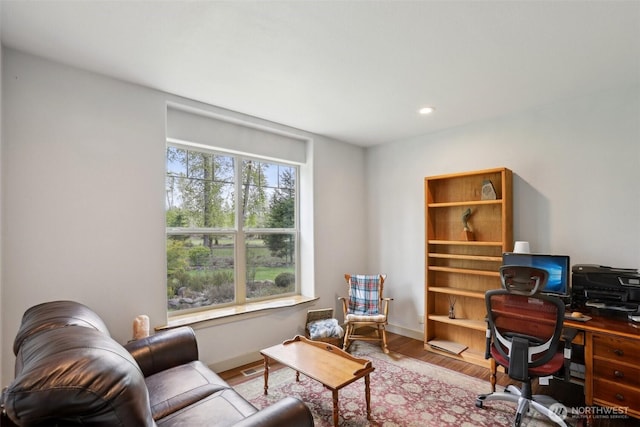home office featuring baseboards, wood finished floors, and recessed lighting