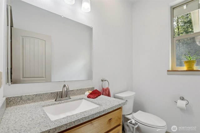 bathroom featuring toilet and vanity