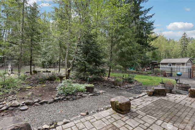 view of patio with a forest view and fence