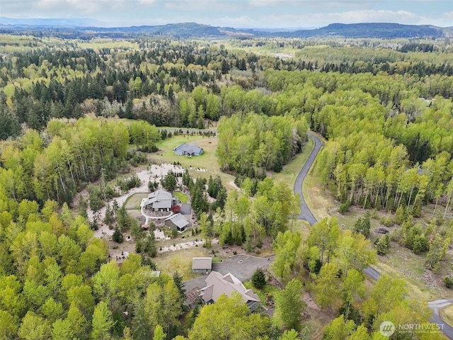 drone / aerial view featuring a view of trees