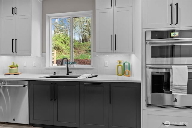 18122 83rd Ave NE, Kenmore, WA 98028 - kitchen featuring light countertops, tasteful backsplash, a sink, and stainless steel appliances