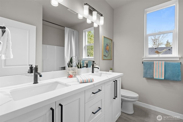 18122 83rd Ave NE, Kenmore, WA 98028 - full bath with double vanity, baseboards, a sink, and toilet
