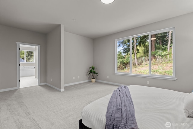 18122 83rd Ave NE, Kenmore, WA 98028 - bedroom with light colored carpet, baseboards, and connected bathroom