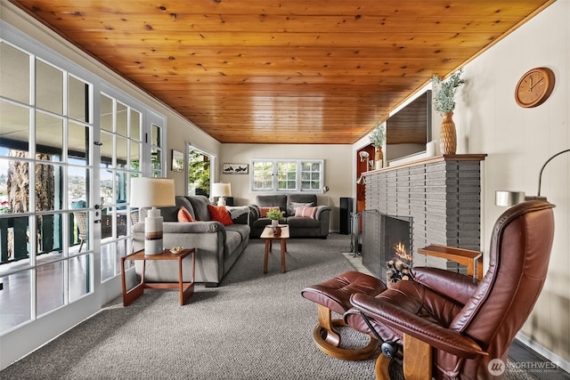 living area with carpet floors, wooden ceiling, and a brick fireplace