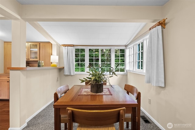 dining area featuring baseboards, vaulted ceiling, visible vents, and carpet floors