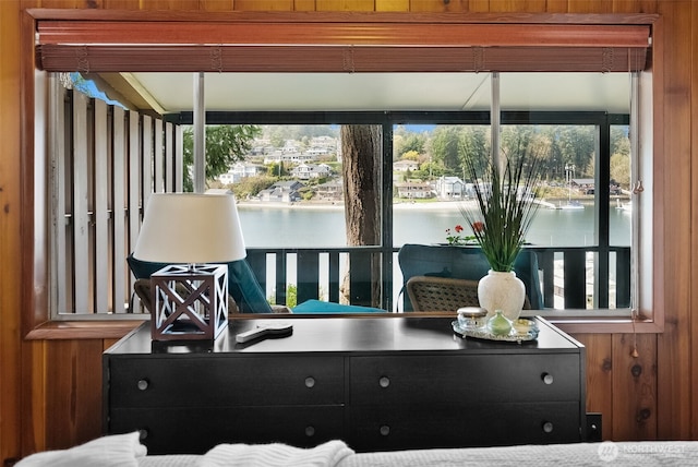 interior space with wood walls and a water view