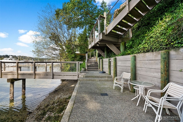 exterior space featuring a patio area, stairway, and fence